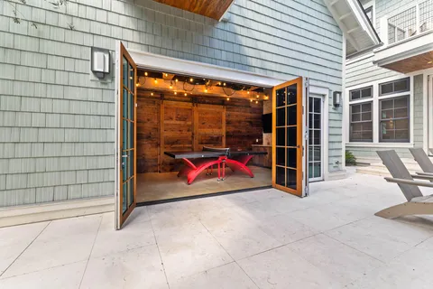 a view of a balcony with floor to ceiling windows with wooden floor