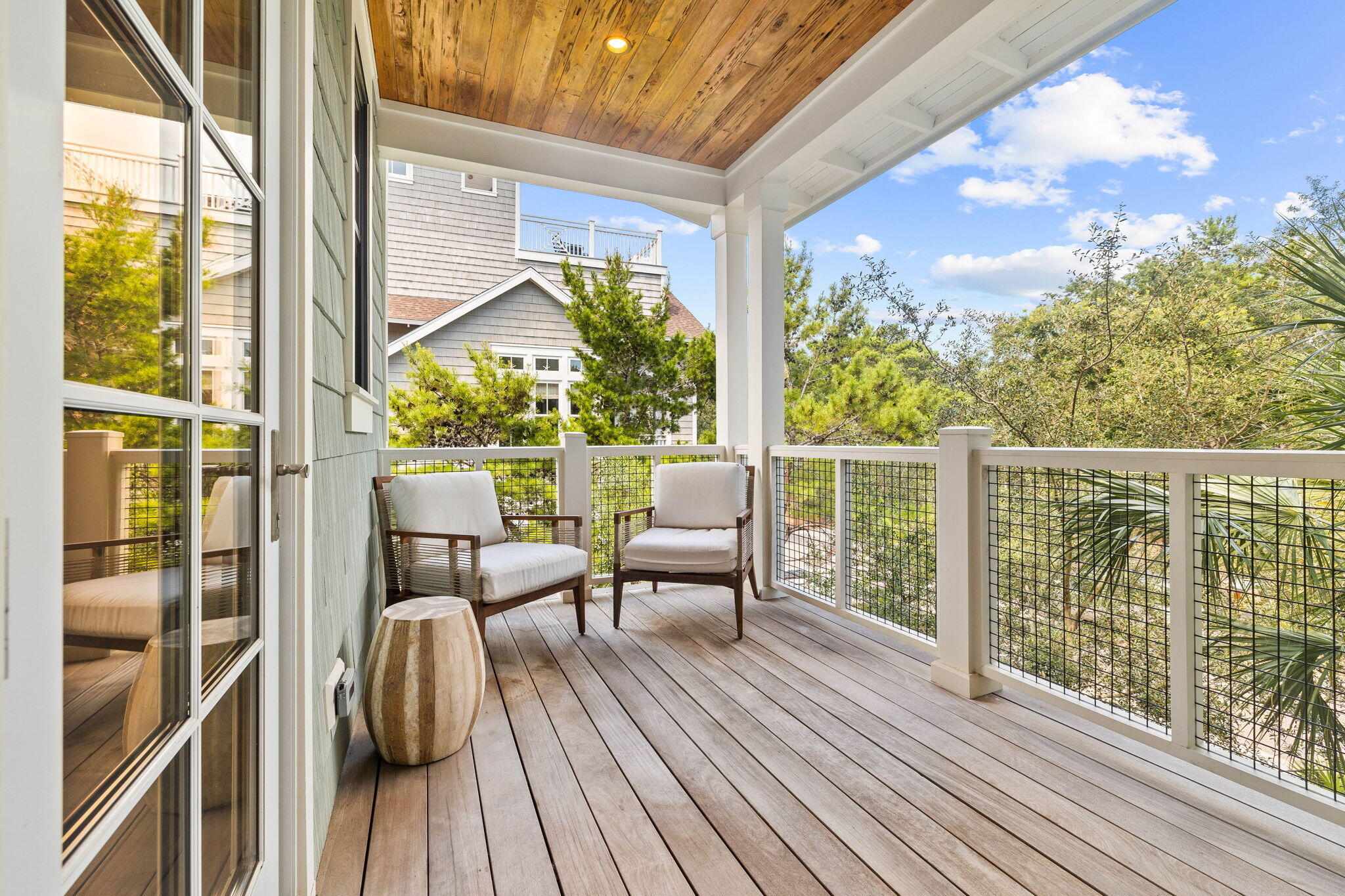 58 Coopersmith Ln Inlet Beach Inlet Beach, FL 32461 - Photo 79 of 130 a balcony with wooden floor table and chairs