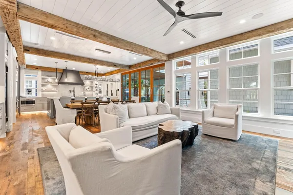 a large kitchen with kitchen island a sink stove and a dining table