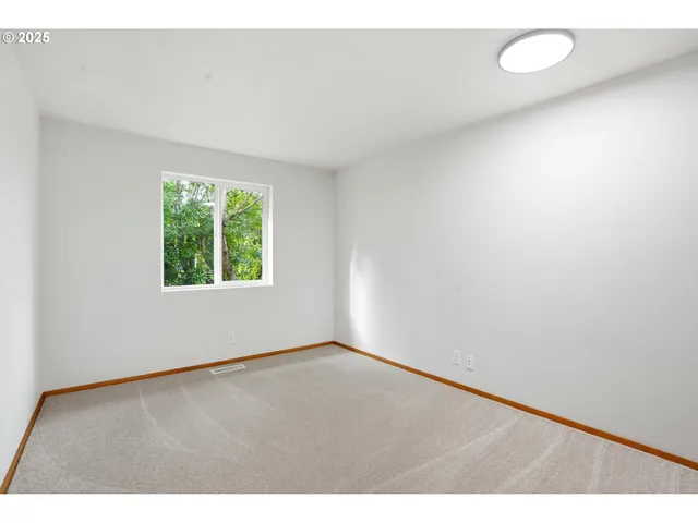 a bedroom with a bed a couch and chandelier