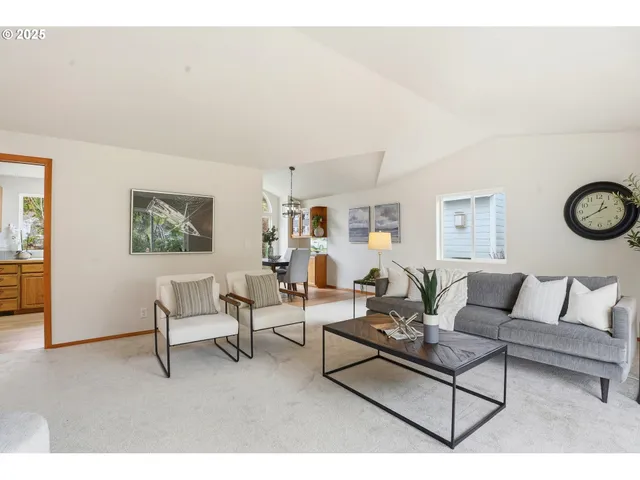 a living room with furniture and a wall painting