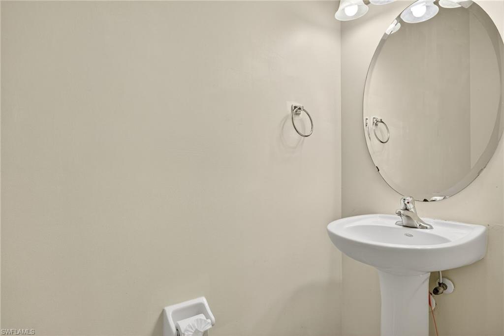 7666 Bristol Circle Naples, FL 34120 - Photo 16 of 20 a bathroom with a sink and mirror