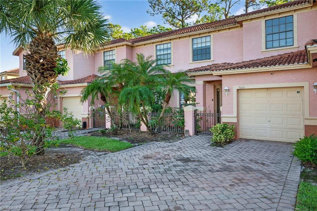 7666 Bristol Circle Naples, FL 34120 - Photo 19 of 20 a front view of a house with garden