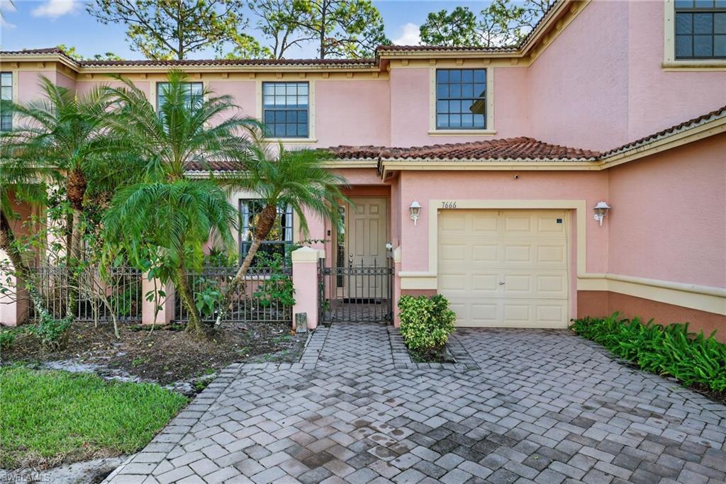 7666 Bristol Circle Naples, FL 34120 - Photo 20 of 20 a front view of a house with garden