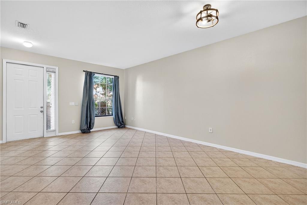 7666 Bristol Circle Naples, FL 34120 - Photo 6 of 20 an empty room with windows