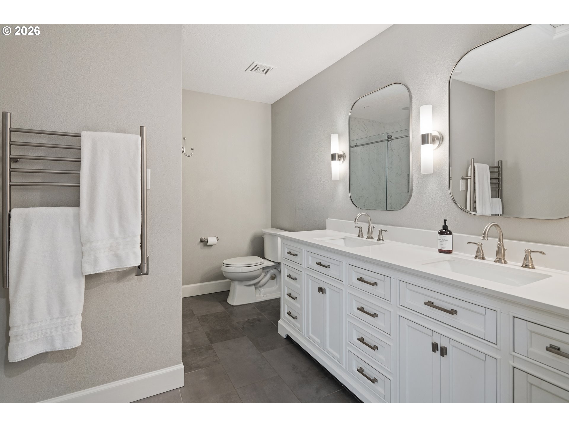 2545 Northwest 12th Circle Camas, WA 98607 - Photo 29 of 46 a spacious bathroom with a double vanity sink a mirror and a toilet