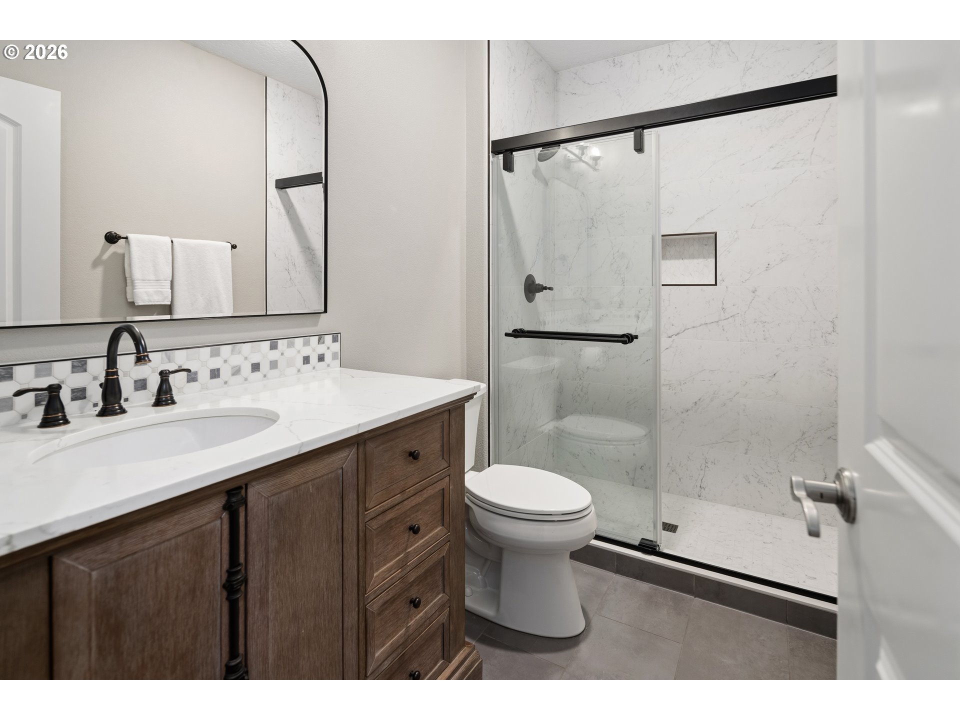 2545 Northwest 12th Circle Camas, WA 98607 - Photo 36 of 46 a bathroom with a sink toilet a mirror and shower