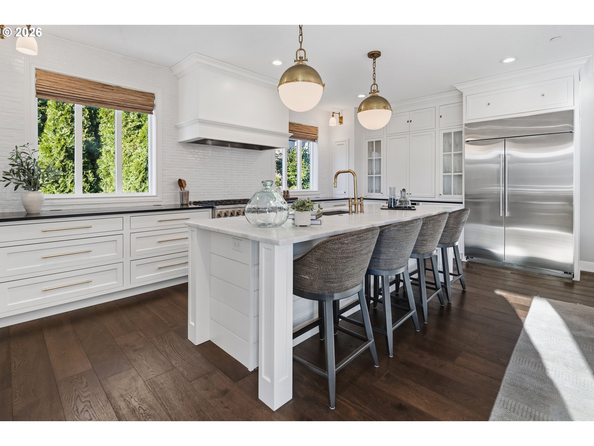 2545 Northwest 12th Circle Camas, WA 98607 - Photo 6 of 46 a kitchen with a dining table a clock and a large window