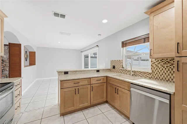 a kitchen with a sink stove and cabinets