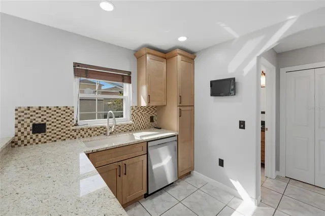 a spacious bathroom with a granite countertop sink a toilet and shower