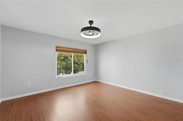 a view of a room with wooden floor and window