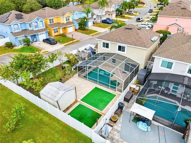 an aerial view of residential houses with yard
