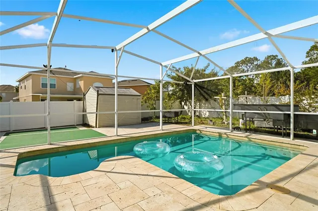 a view of a backyard with a swimming pool