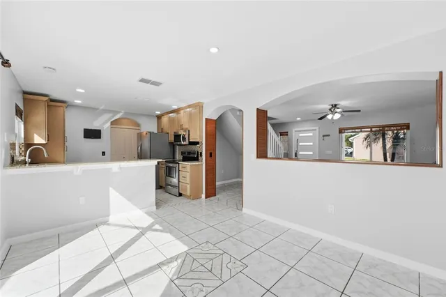 a view of kitchen with furniture and refrigerator