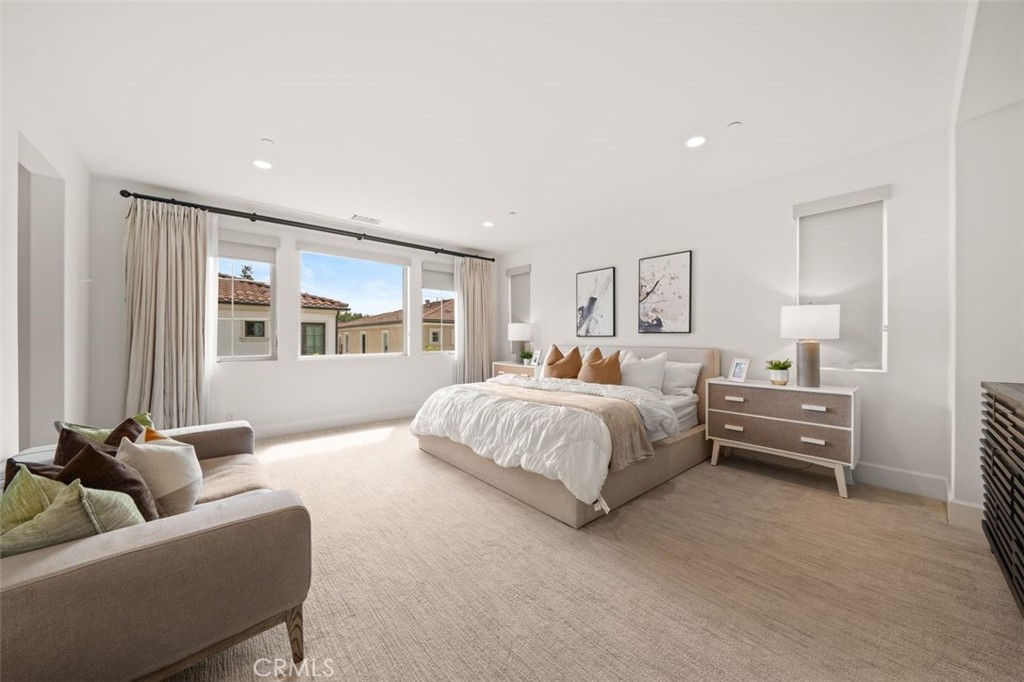 90 Rockinghorse Irvine, CA 92602 - Photo 14 of 30 a spacious bedroom with a bed and a couch