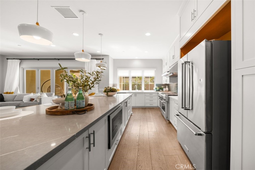 90 Rockinghorse Irvine, CA 92602 - Photo 7 of 30 a kitchen with counter top space a sink appliances and cabinets