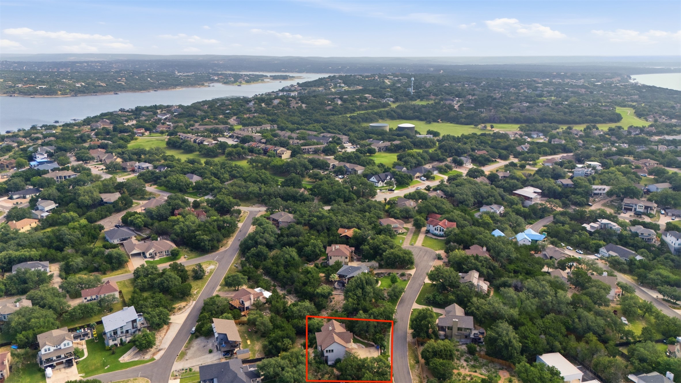 700 Augusta Circle Point Venture, TX 78645 - Photo 27 of 35 An aerial perspective reveals a charming property nestled amidst a verdant landscape, bordering a serene lake.