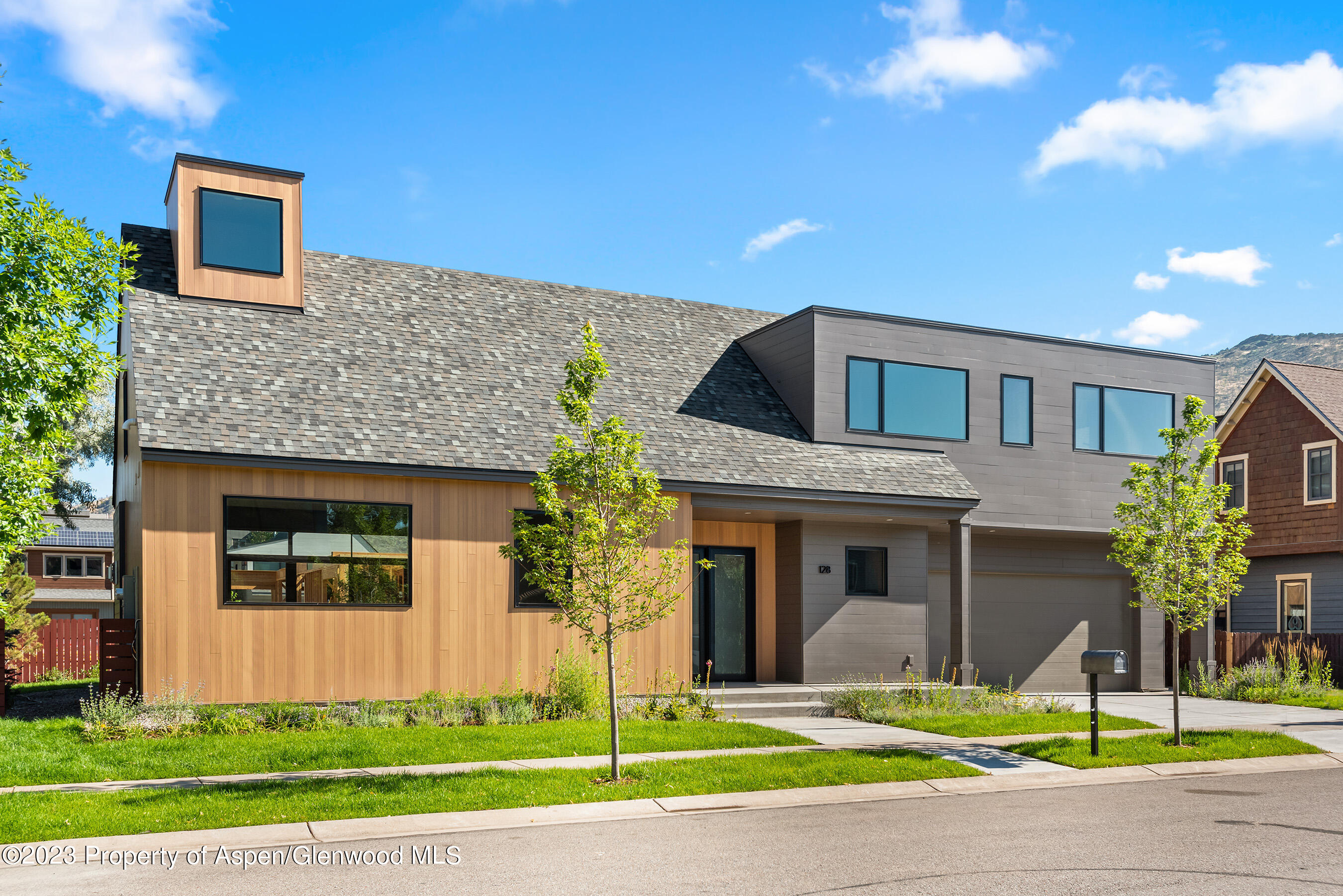 128 Valley Court Basalt, CO 81621 - Photo 2 of 12 a front view of a house with a yard and garage