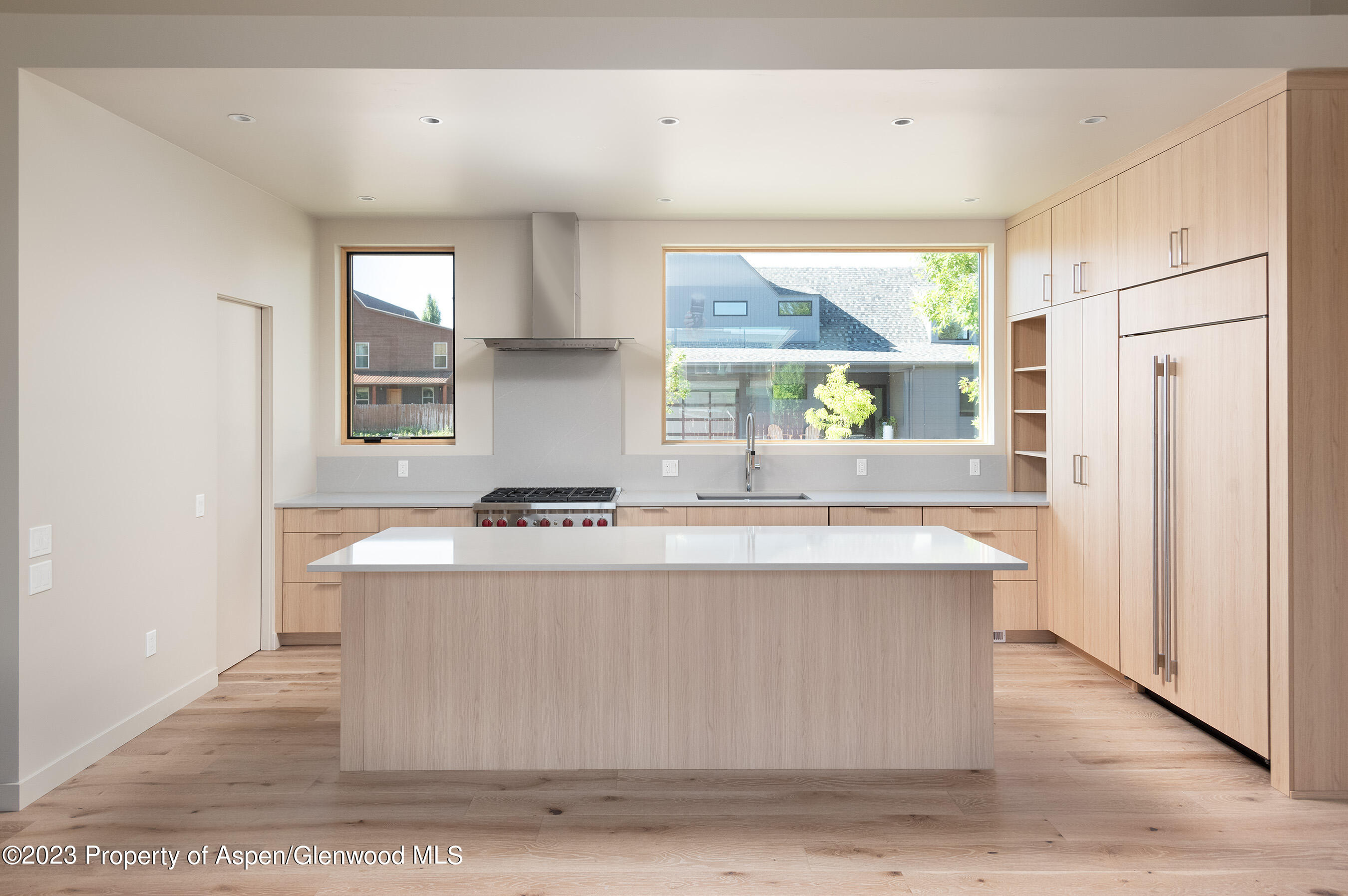128 Valley Court Basalt, CO 81621 - Photo 5 of 12 a kitchen with kitchen island a sink wooden floor and a large window