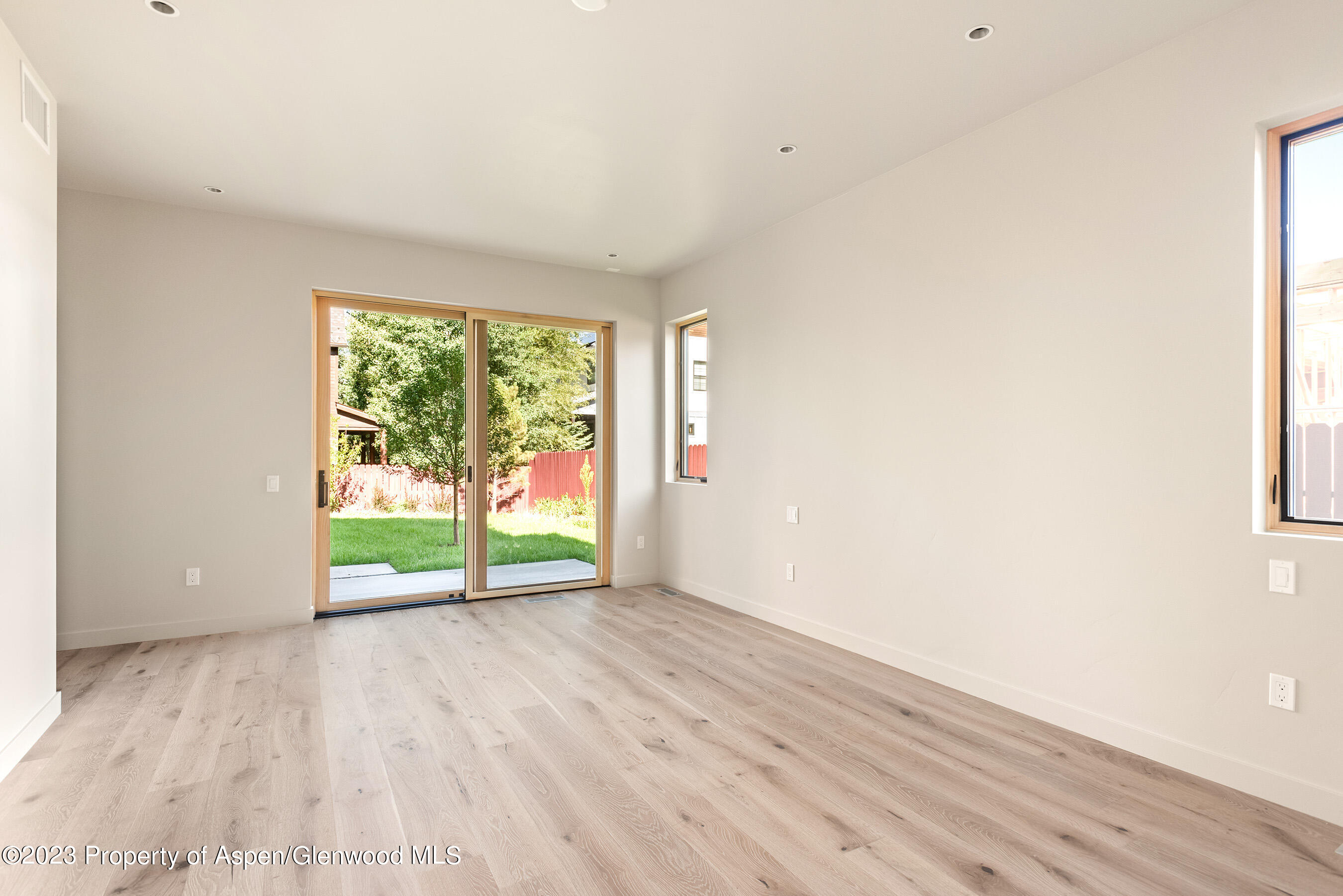 128 Valley Court Basalt, CO 81621 - Photo 6 of 12 a view of an empty room with wooden floor and a window