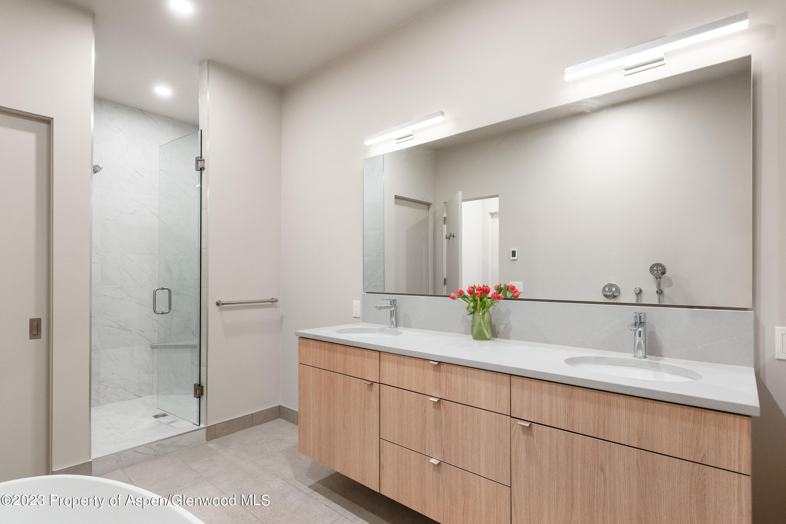 128 Valley Court Basalt, CO 81621 - Photo 7 of 12 a bathroom with a double vanity sink mirror and shower