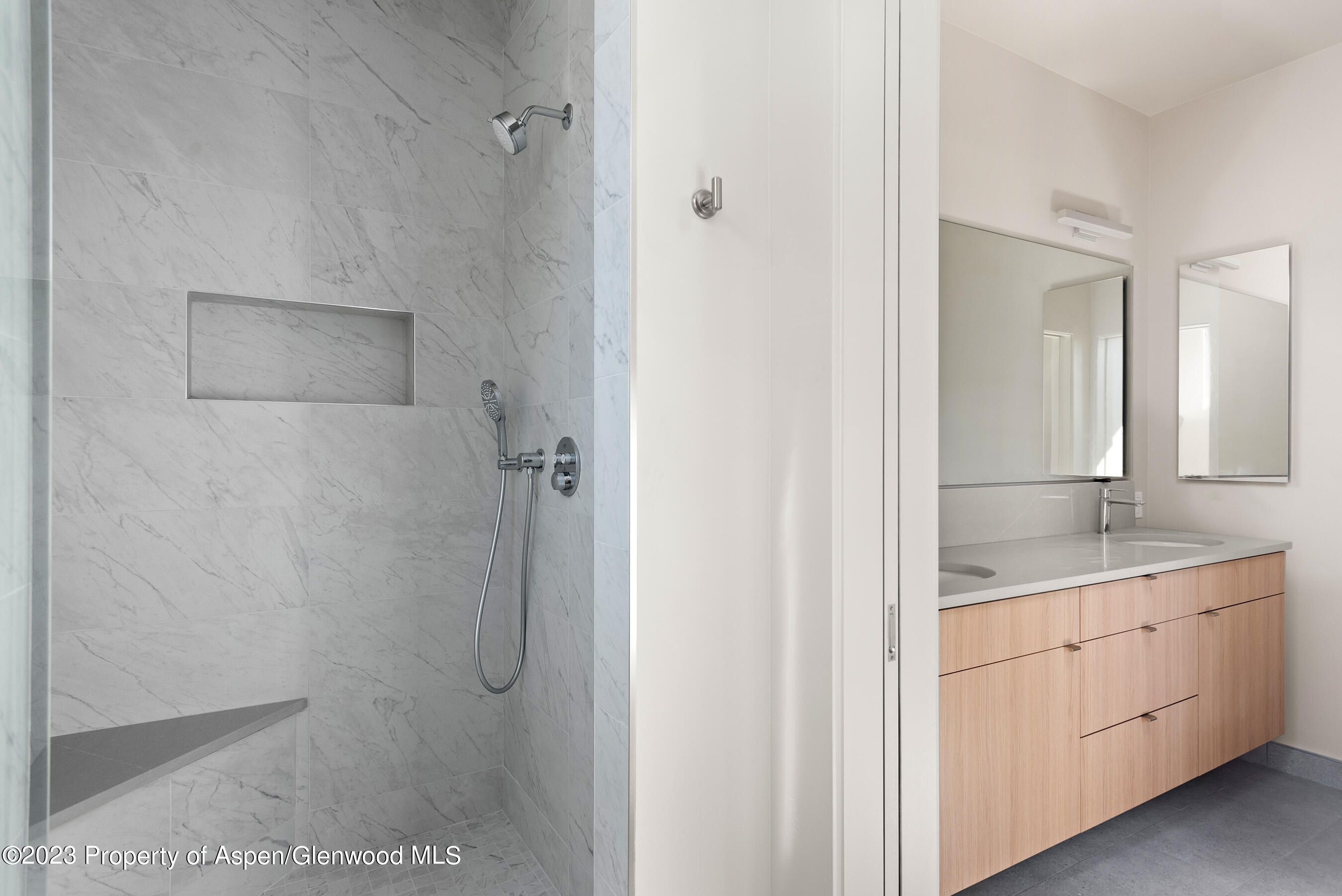 128 Valley Court Basalt, CO 81621 - Photo 9 of 12 a bathroom with a granite countertop sink a mirror and a shower
