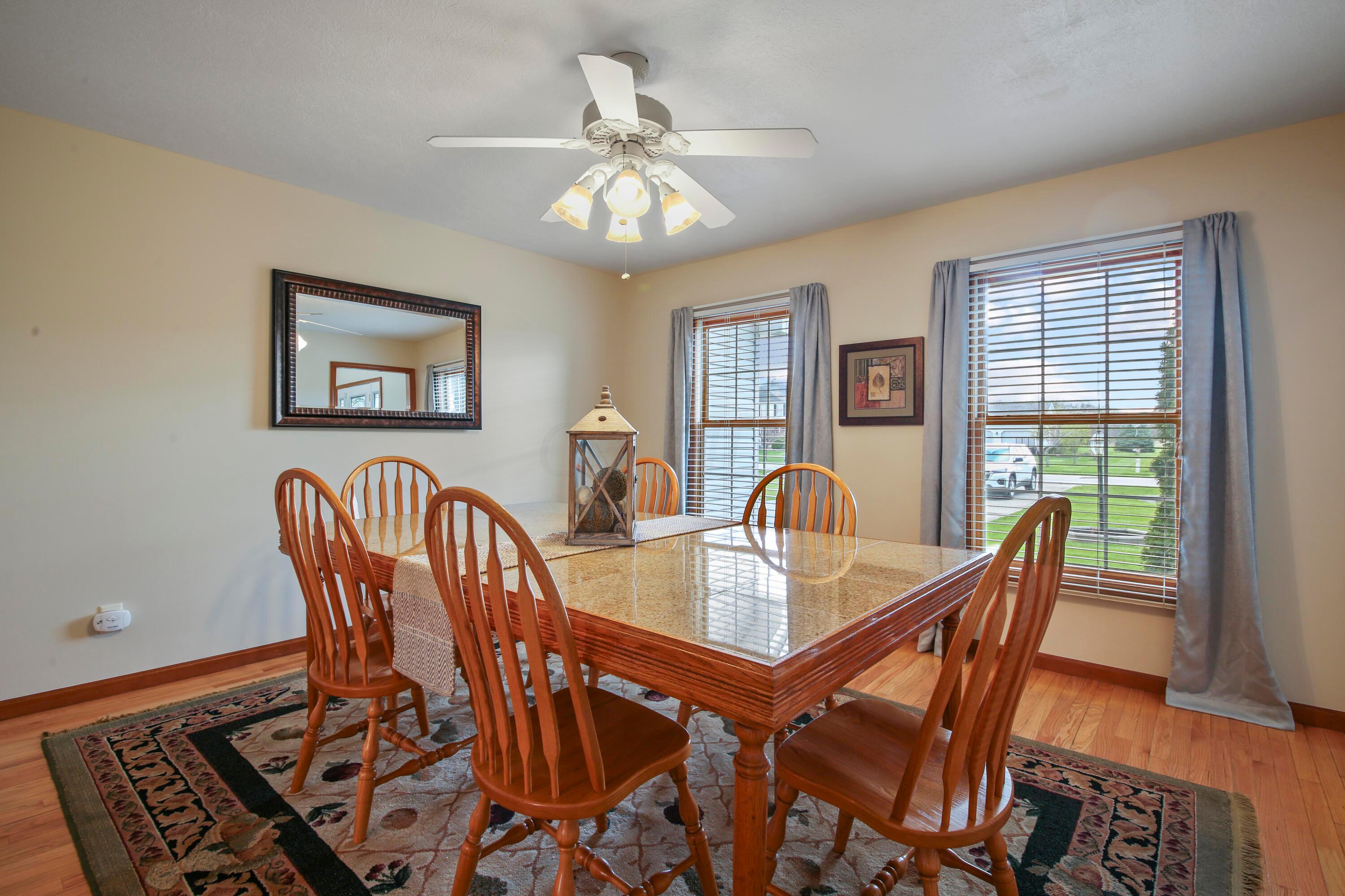 3273 Gooding Road Marion, OH 43302 - Photo 22 of 60 Dining Room 13’4 x 13’8 features double windows w/decorative shades and drapes, overhead ceiling fan with light fixture, hardwood floors and neutral paint.