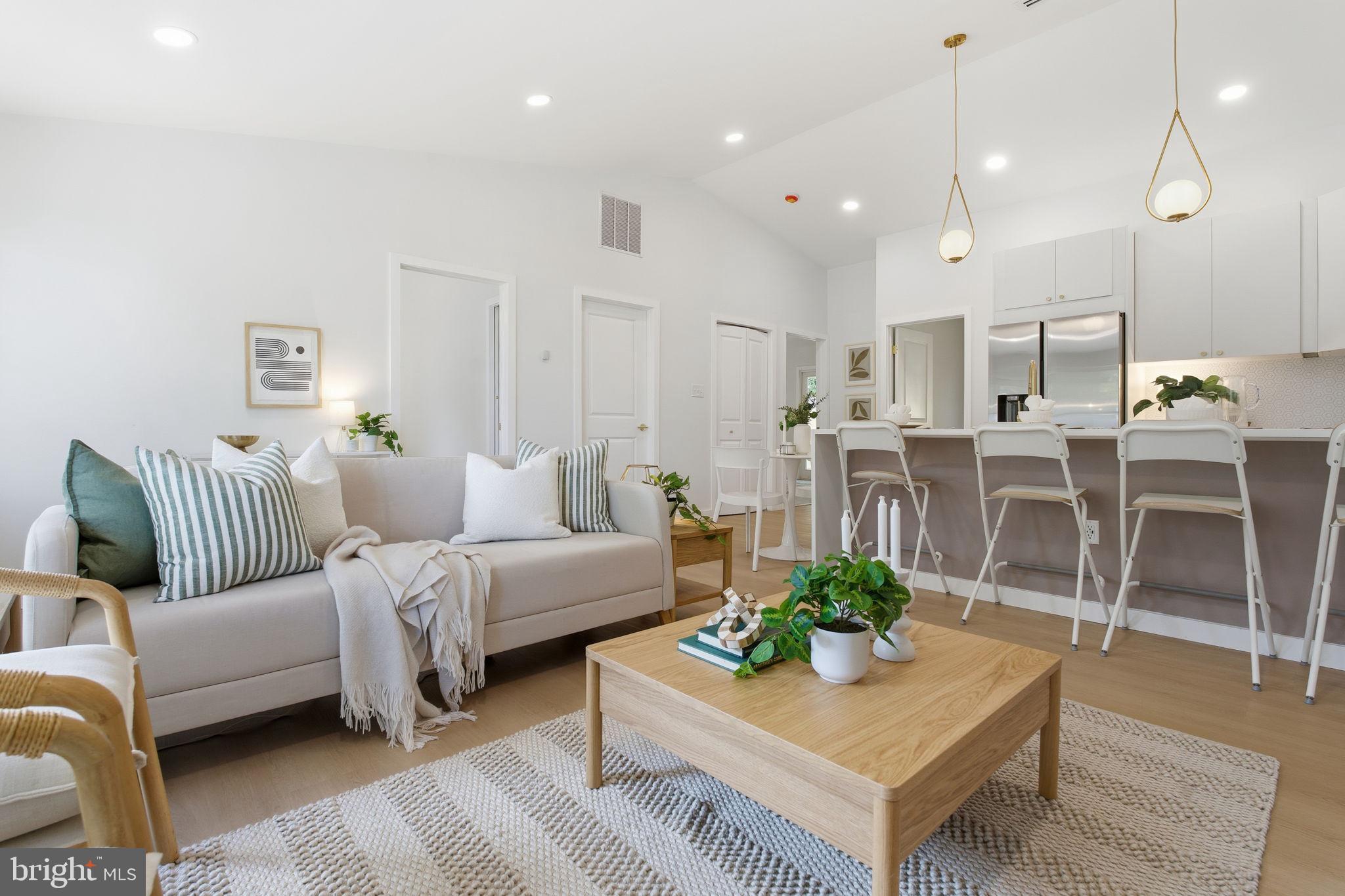 120 Haverhill Road Joppa, MD 21085 - Photo 11 of 33 a living room with furniture a rug kitchen view and a chandelier