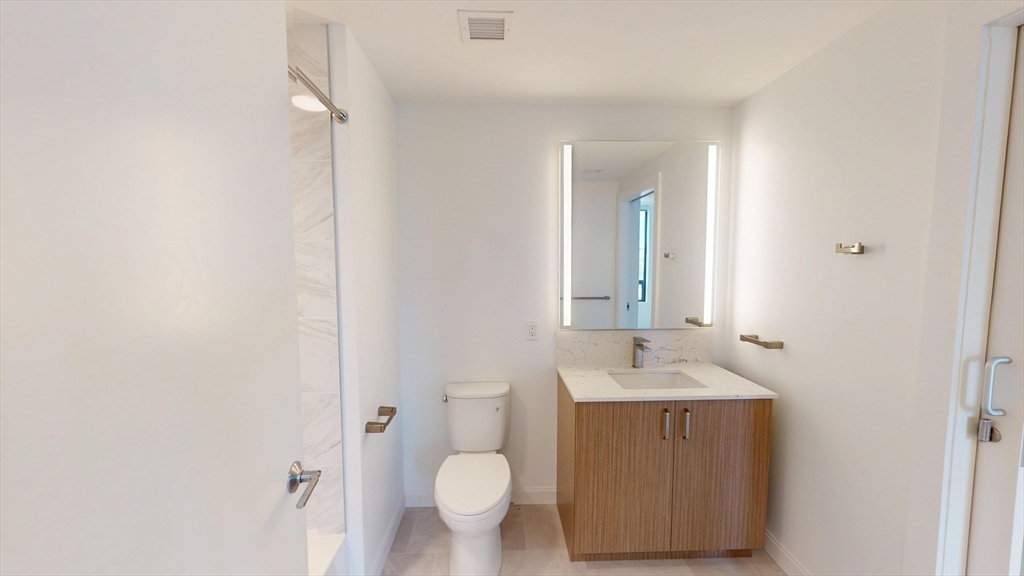 60 Kilmarnock Street, Unit 842 Boston, MA 02215 - Photo 12 of 13 a bathroom with a sink and a mirror