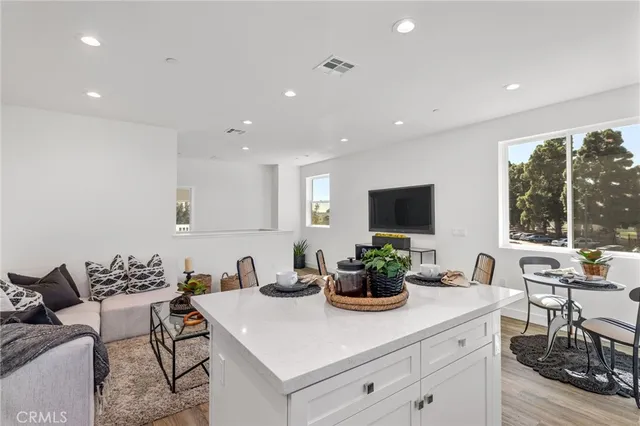 a kitchen with a sink and living room