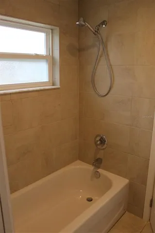 a bathroom with a bath tub and a shower