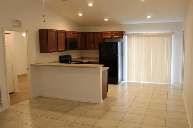 a kitchen with stainless steel appliances a refrigerator sink and microwave