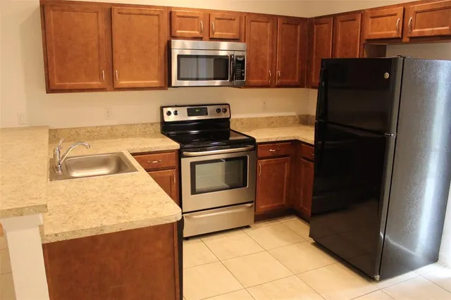 a kitchen with a refrigerator stove and microwave