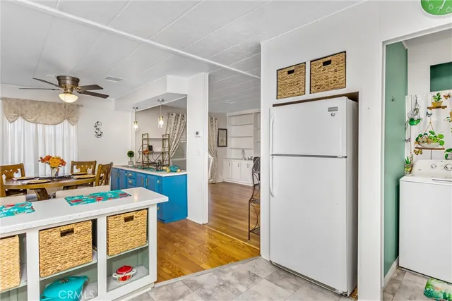 a kitchen with stainless steel appliances granite countertop a refrigerator a stove and a sink