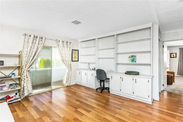 a view of empty room with cabinet and window