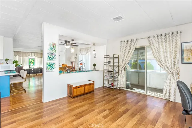 a living room with fireplace furniture and a wooden floor