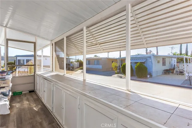 a large white kitchen with sink and large windows
