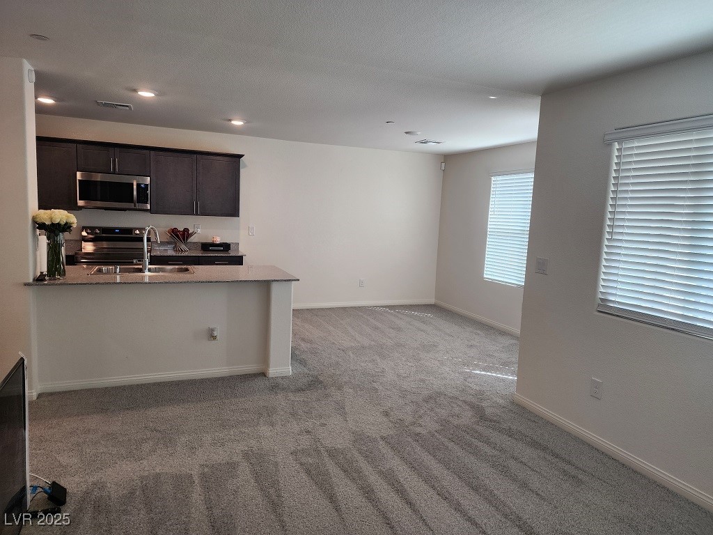 6925 Spicy Merlot Street North Las Vegas, NV 89086 - Photo 17 of 33 Kitchen featuring baseboards, a sink, stainless st