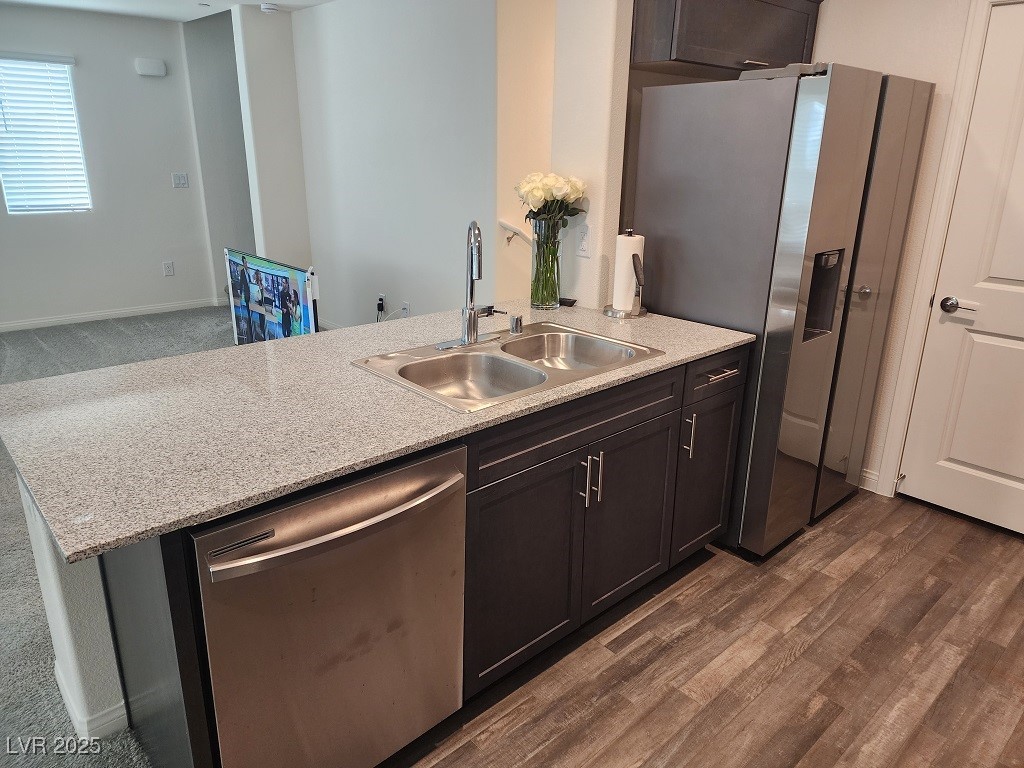 6925 Spicy Merlot Street North Las Vegas, NV 89086 - Photo 9 of 33 Kitchen with dark wood-type flooring, light stone