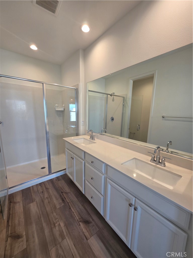120 Rondo Irvine, CA 92618 - Photo 11 of 23 a spacious bathroom with a double vanity sink a large mirror and shower