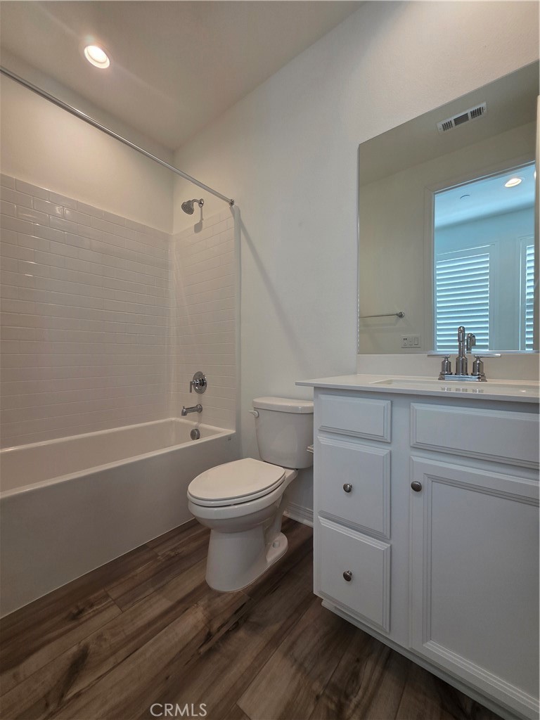 120 Rondo Irvine, CA 92618 - Photo 17 of 23 a bathroom with a toilet a sink a mirror and vanity