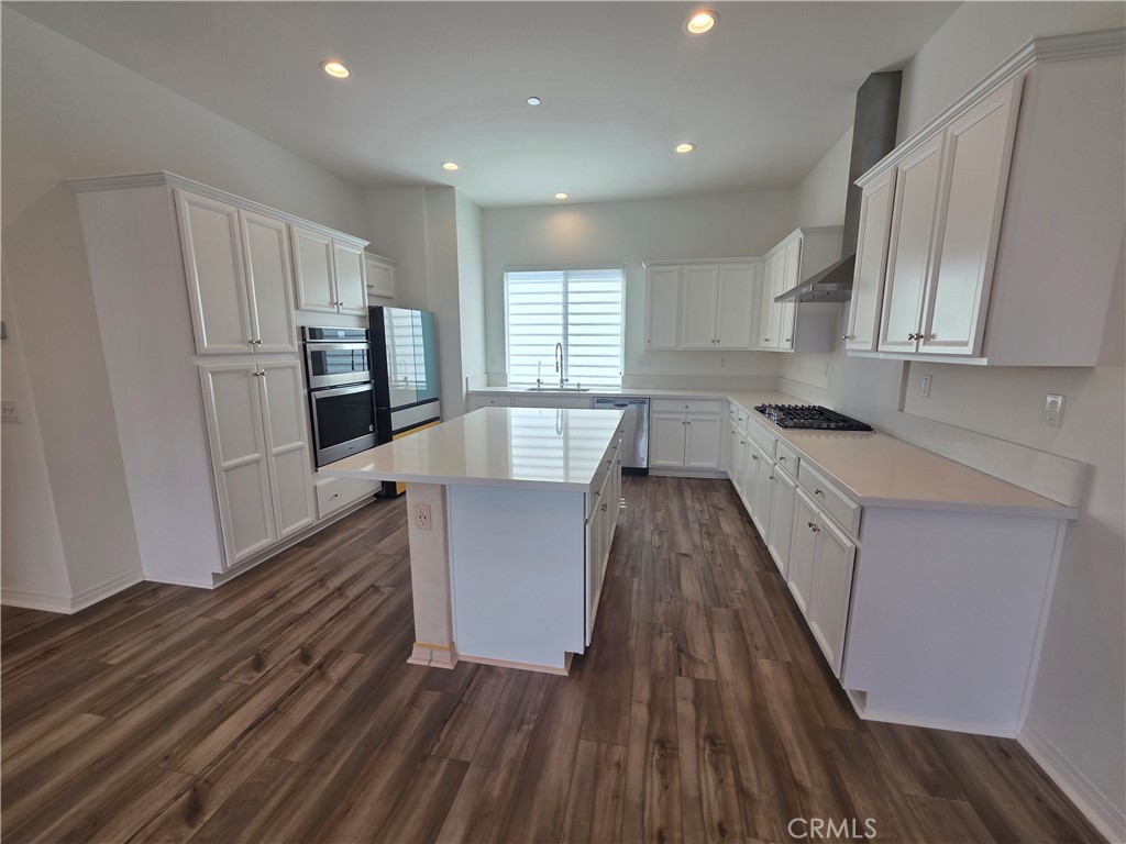 120 Rondo Irvine, CA 92618 - Photo 3 of 23 a kitchen with sink cabinets and wooden floor