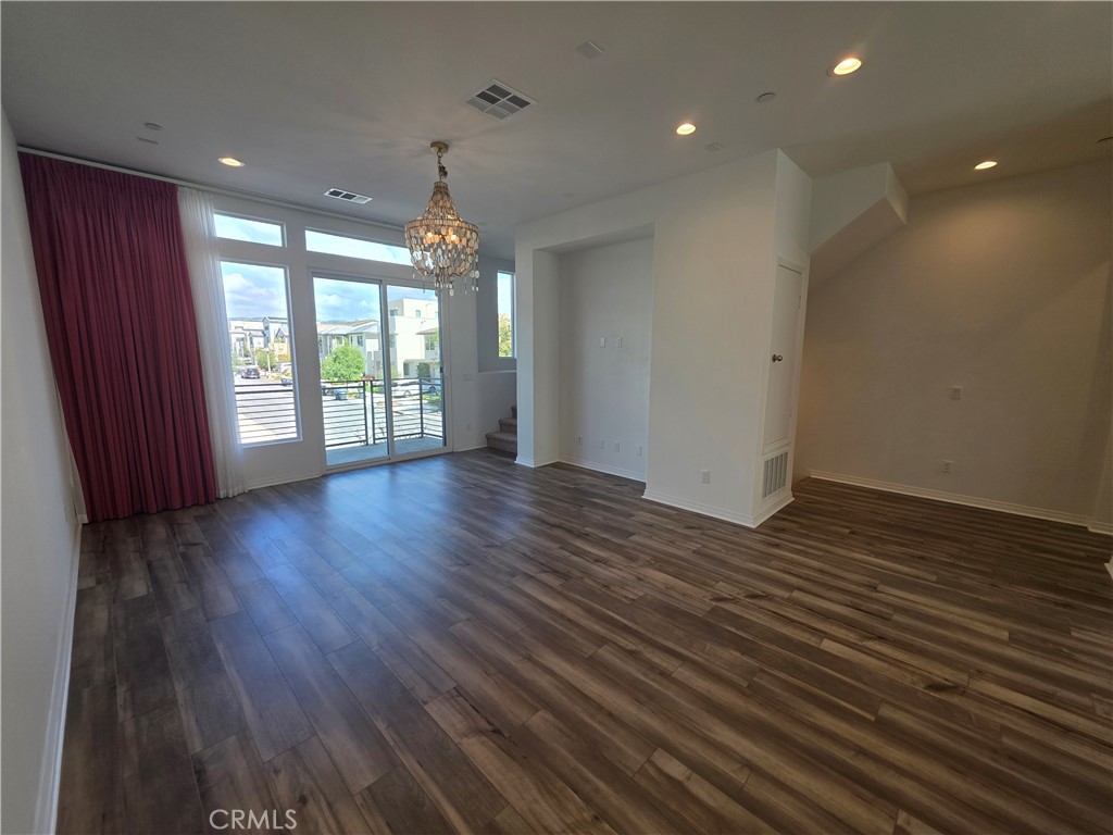120 Rondo Irvine, CA 92618 - Photo 5 of 23 a view of an empty room with wooden floor and a window