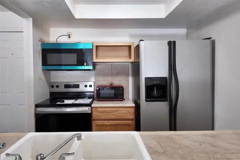 a kitchen with stainless steel appliances a refrigerator stove and microwave