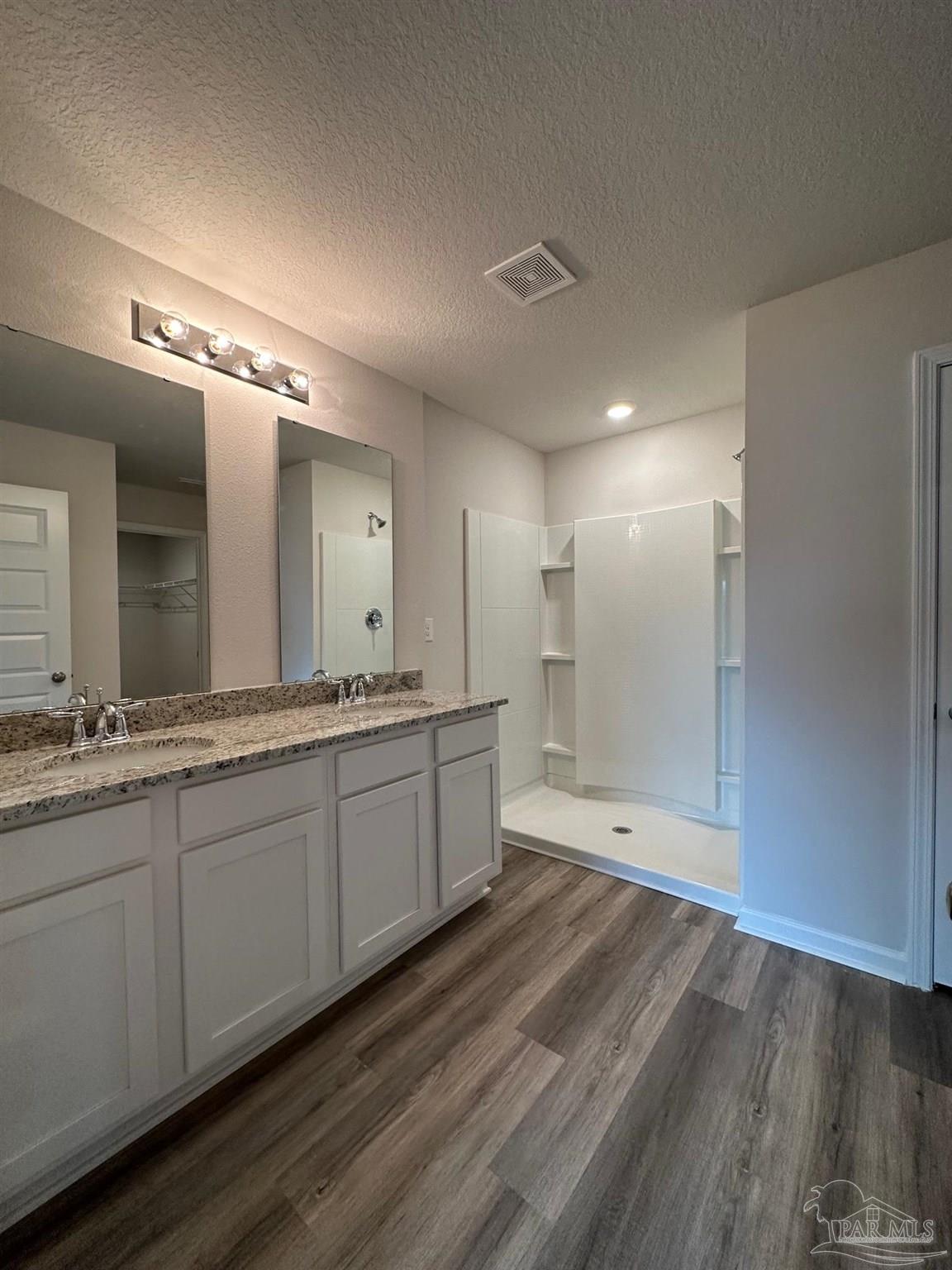 4378 Redbay Court Pace, FL 32571 - Photo 21 of 30 a bathroom with double vanity sinks and a mirror
