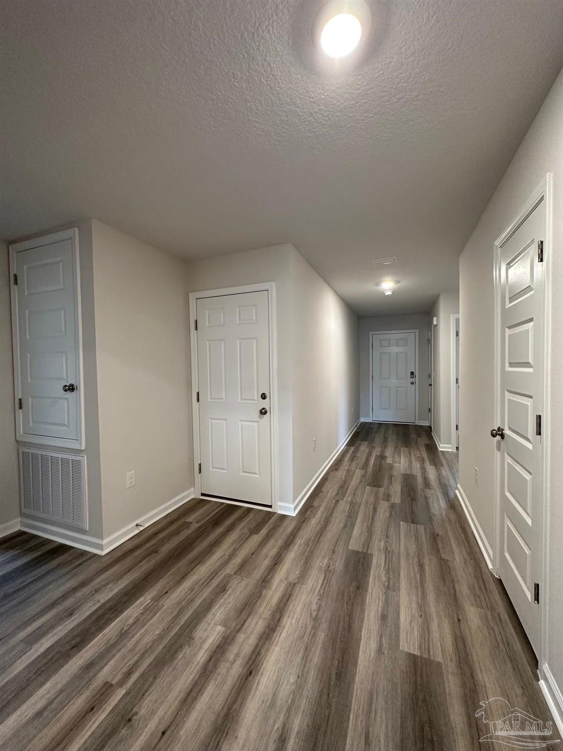 4378 Redbay Court Pace, FL 32571 - Photo 7 of 30 a view of an empty room and wooden floor