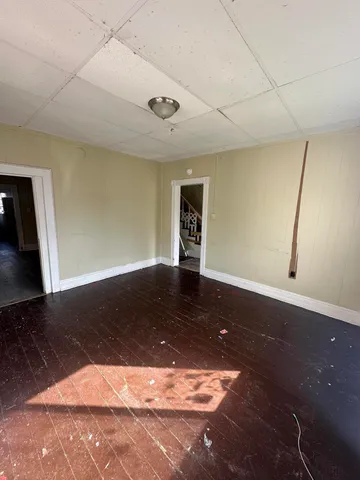 a view of a room with wooden floor