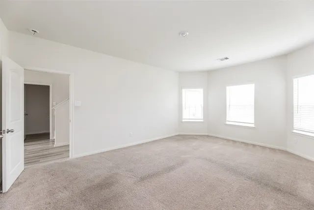 an empty room with windows and closet