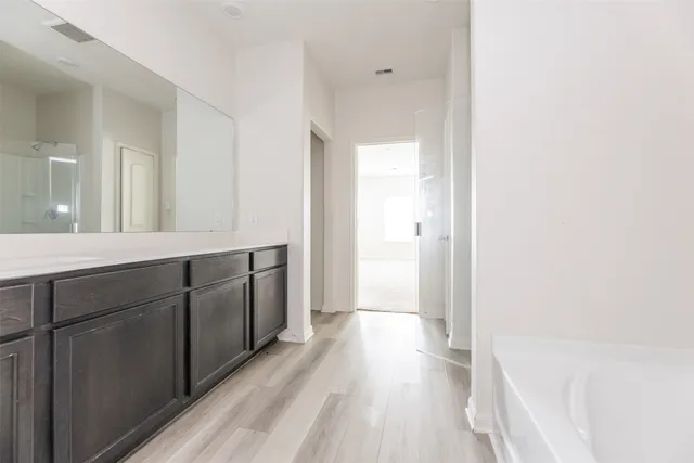 a spacious bathroom with a shower and a sink