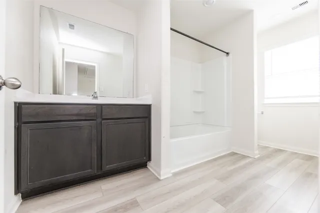 a bathroom with a bathtub and a sink